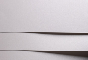 Aufkleber - White pearl paper background with a glossy satin texture and layered folded strips. Icy silver and pale grey tones create a soft, elegant, and luxurious abstract composition with crisp contours,.