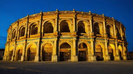 Poster - A large building with arches lit up at night, suitable for architectural or cityscape photography.