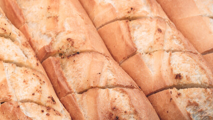 Poster - A close up of a loaf of bread with the slices cut out. The bread is brown and has a crust.