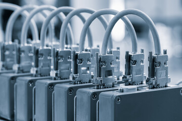 Poster - A row of boxes with wires coming out of them. The boxes are all the same size. The wires are white.