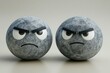© DZIKRA  - Two rock-textured spheres with angry expressions on a neutral background