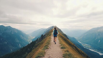 Aufkleber - A woman climbs up a steep mountain path with determination and focus.