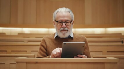 Poster - A person working on a tablet computer in a lecture hall setting.
