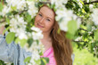 © Andrey_Arkusha - Young red-haired woman posing in a blooming garden