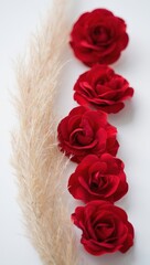 Poster - Red roses on straw background.
