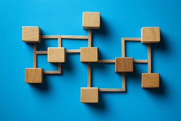Poster - Wooden blocks connected by sticks forming a network on a blue background top down view concept of connection