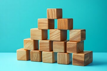 Poster - Pyramid of wooden blocks stacked on a light blue surface creating a simple geometric arrangement view