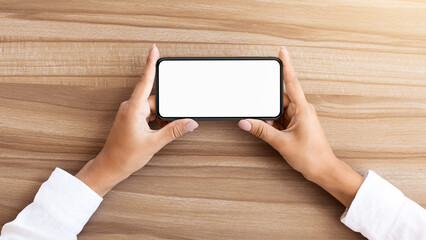Poster - Girl watching video or playing game on cell phone in horizontal position. Isolated screen for app mock up