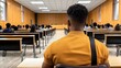 © MUMTAZ - A lone student sits in a lecture hall,  a sea of empty desks stretching before him.  The ambiance is one of quiet contemplation, awaiting the commencement of a new learning experience.