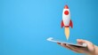 © pkproject - Hand Holding a Digital Rocket Launching from a Tablet, Futuristic Startup Success Concept