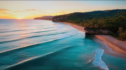 Poster - stunning coastal cliff view at sunset, showcasing gentle waves lapping against sandy beach. vibrant colors of sky reflect on water, creating serene atmosphere