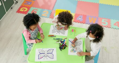 Leinwandbilder - Girls, school and children drawing for art, learning and development in kindergarten classroom. Kids, butterfly and group together for growth, education and above students with color at academy