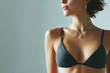 © Papukos - Young woman wearing black bra and silver necklace posing in studio