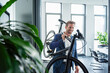 © Westend61 - Businessman in a modern office carrying a bike and smiling