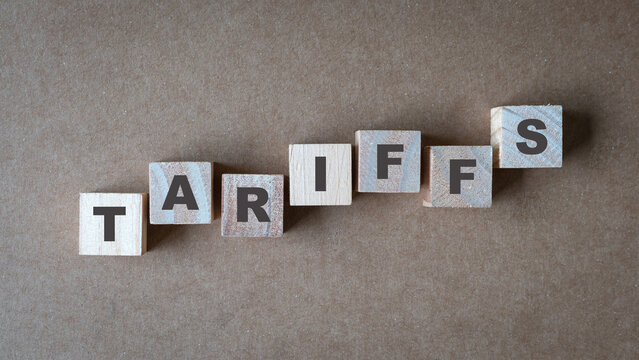 Tariffs, word on square wooden blocks. Top view.