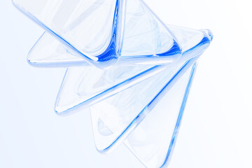 Poster - Abstract light blue 3d background with glass transparent triangle plates, crystal flare, prism sparkle. Clear glossy triangular lens pattern. Graphic design digital technology render. 3D illustration
