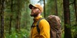 © Passakorn - Eco-Friendly Travel for a Sustainable and Responsible Journey, A hiker in a yellow jacket stands in a lush green forest, looking up thoughtfully.