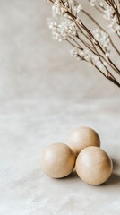 Poster - Decorative wooden spheres arranged on a surface with delicate white flowers in the background during golden hour light