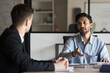 © fizkes - Professional Indian CEO leader speaking to colleagues at international business employees meeting in boardroom, discussing marketing project, developing financial ideas, managing corporate operations