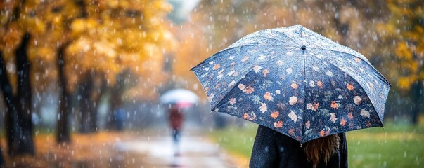 Aufkleber - Woman with floral umbrella walking in a rainy autumn park