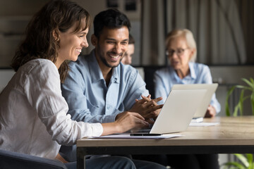 two happy professional executives partners work with laptop, businessman and businesswoman use compu