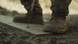 © Fidel - Concrete worker smoothing the surface of fresh concrete with a trowel. Featuring attention to detail and precision