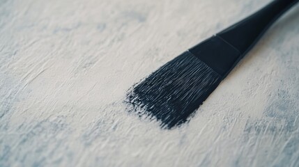 Leinwandbilder - A diagonal bold black paintbrush stroke graces white textured paper, highlighting the bristles' fine details while providing ample copy space on the right