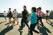 © Jacob Lund - Group of people running together in a community outdoor event
