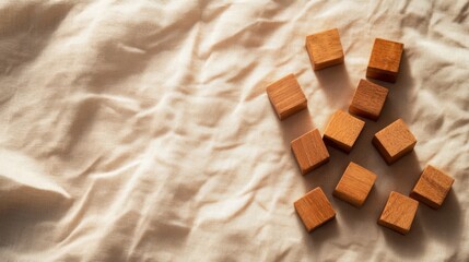 Poster - Wooden block letters form a creative word on a textured beige surface, with shadows enhancing the three-dimensional effect and providing copy space for design use