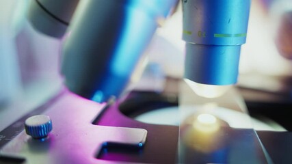 Wall Mural - sterile gloved lab technician focusing microscope lens while conducting precise biomedical research 