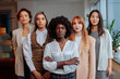 © bernardbodo - Serious businesswoman posing in front of her colleagues