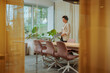 © bernardbodo - Businesswoman preparing for the meeting in the glass office