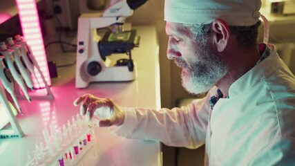 Wall Mural - laboratory technician analyzing colorful test tubes, performing experiments in a modern laboratory w
