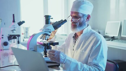 Wall Mural - medical research scientist carefully analyzing biological samples using high tech microscope and lap