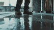 © Soulc - Construction laborer smoothing concrete floor surface. Featuring attention to detail