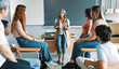 © EFStock - Teenager High School students talking to mature female teacher. Group support conversation in Higher Education