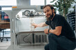 © standret - Product is ready. Man is in the office with 3d printer