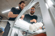 © standret - Showing the 3d printer. People are in the office