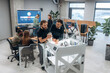 © standret - Group of people are standing around the 3d printer in office