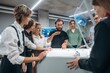 © standret - Explaining how the device works. People are in the office by the 3d printer