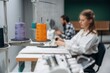 © standret - View from the side, sitting. People are working by the sewing machines indoors