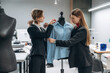 © standret - Fashion concept. People are working by the sewing machines indoors