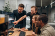 © standret - By computer. Designer team are together in the office