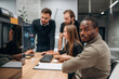 © standret - By computer. Designer team are together in the office