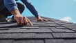 © keshia - Roofing contractor inspecting roof shingles for damage. Featuring expertise and attention to detail