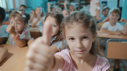 Poster - School Kids Give Thumbs up in Lively Classroom Setting Generative AI