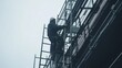 © Allie - Construction worker securing scaffolding on a building site. Featuring strength and safety