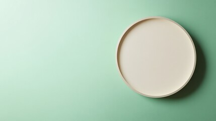 Poster - Round tray on green background creating a minimalist product display setting