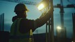 © Allie - Construction worker setting up temporary lighting for a construction site. Featuring preparation and safety