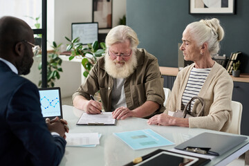 Poster - Senior couple having meeting with manager in office and concluding a contract